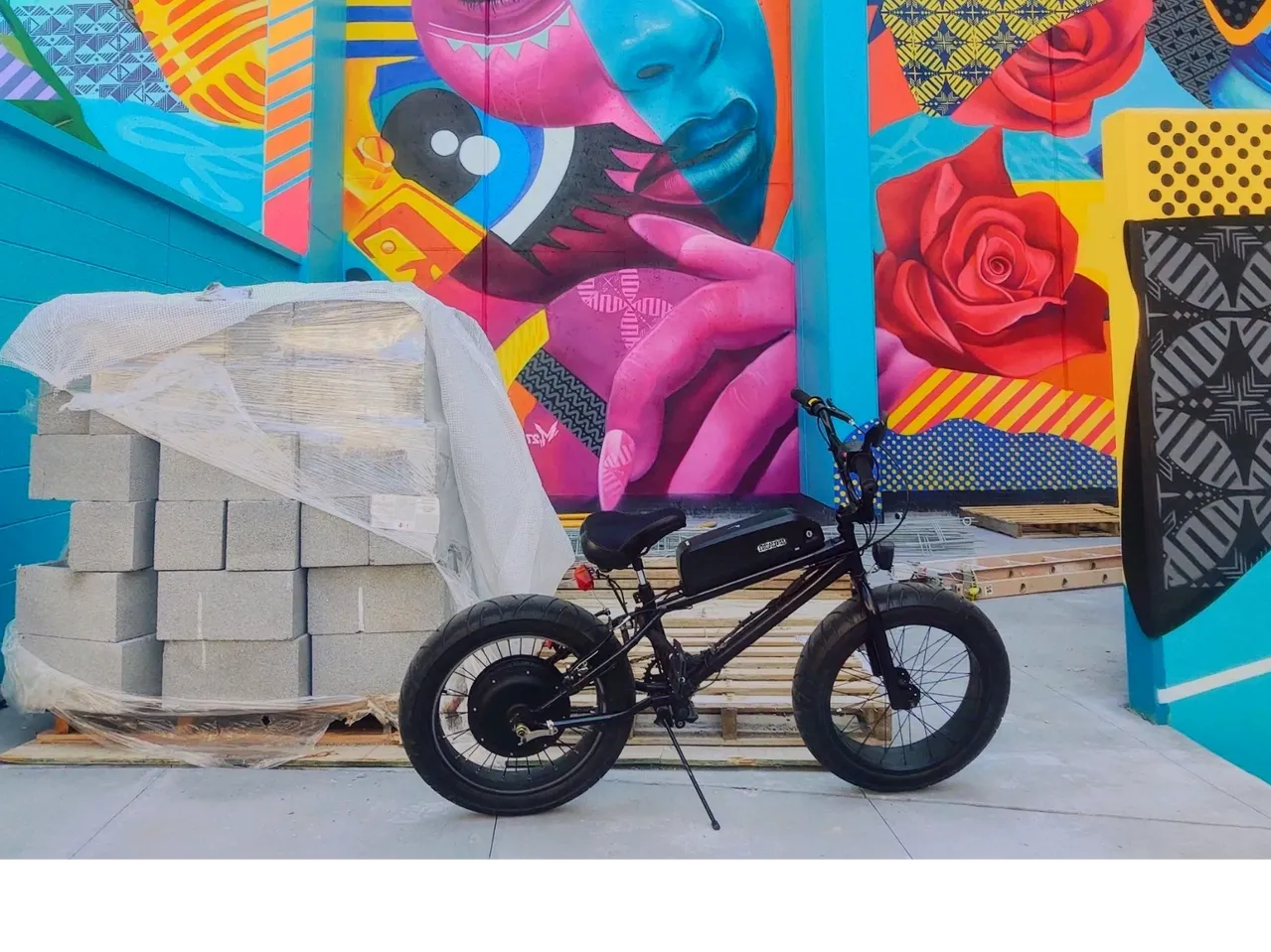 Bicycle parked by vibrant street art