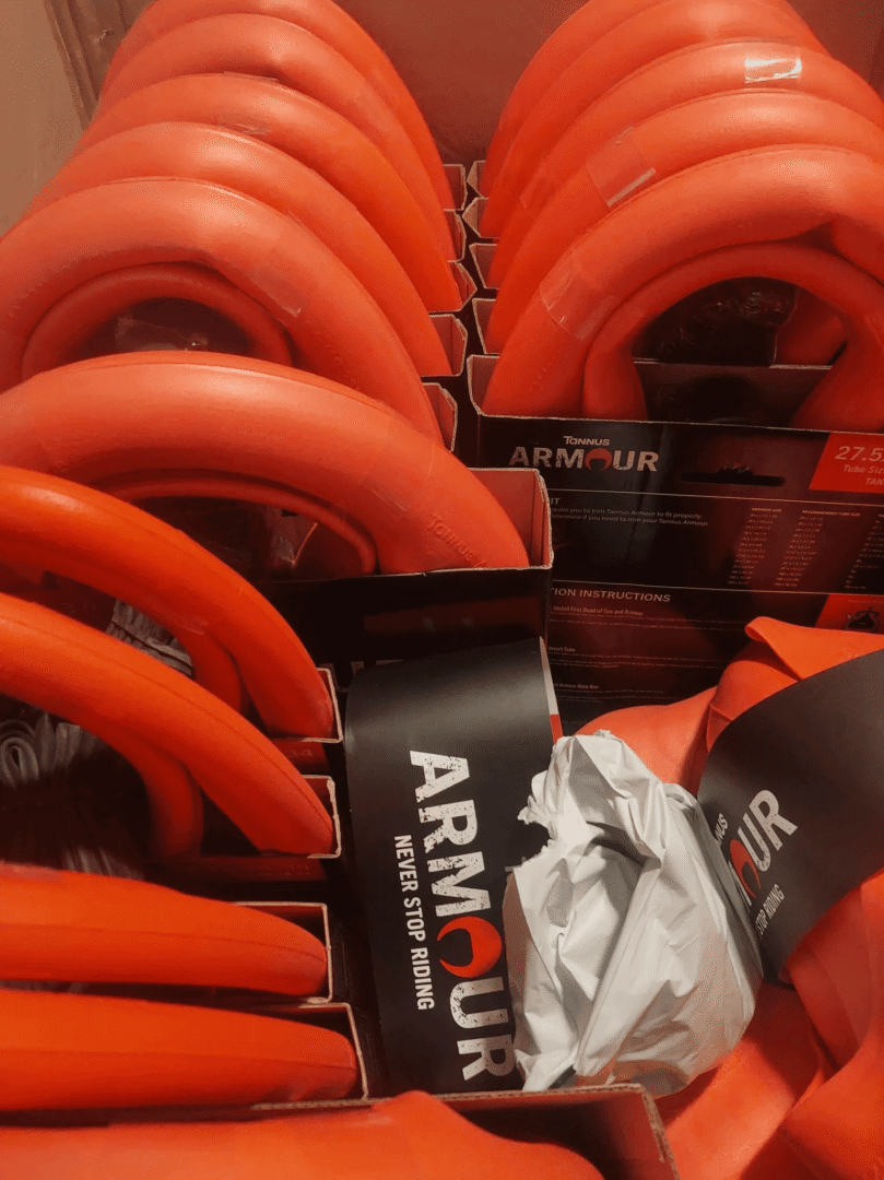 Red bicycle helmets stacked in boxes