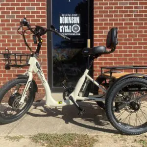 White electric trike beside a shop entrance