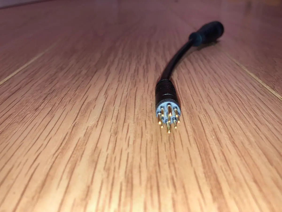 Electrical cable lying on wooden surface.