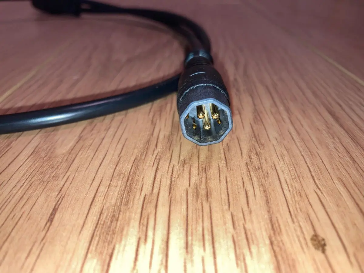 Cable with four-pin connector on wooden floor