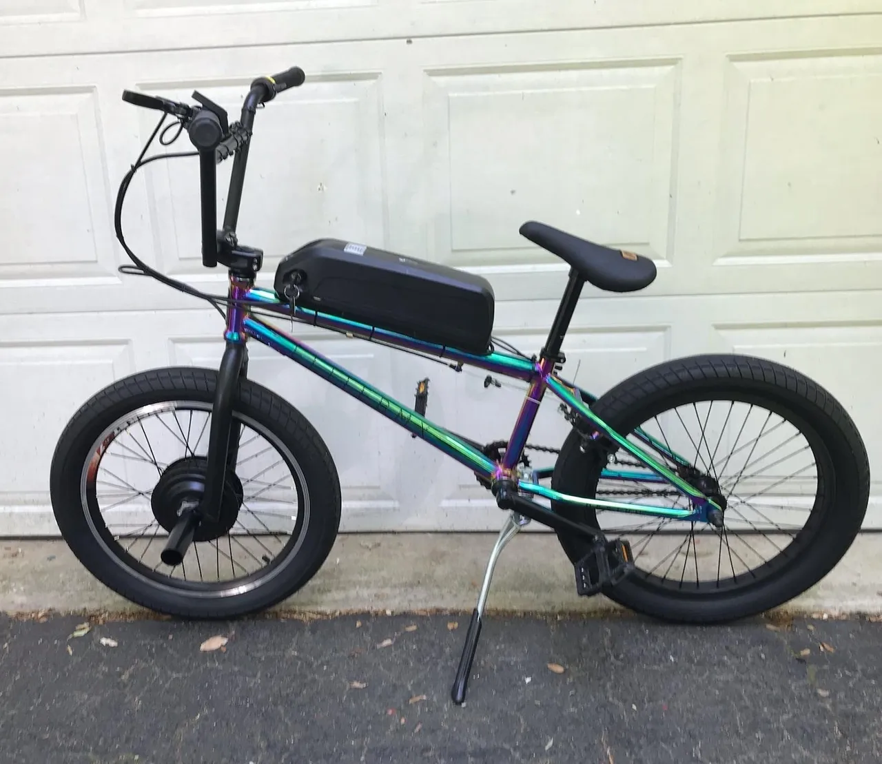 Custom electric bicycle in front of garage