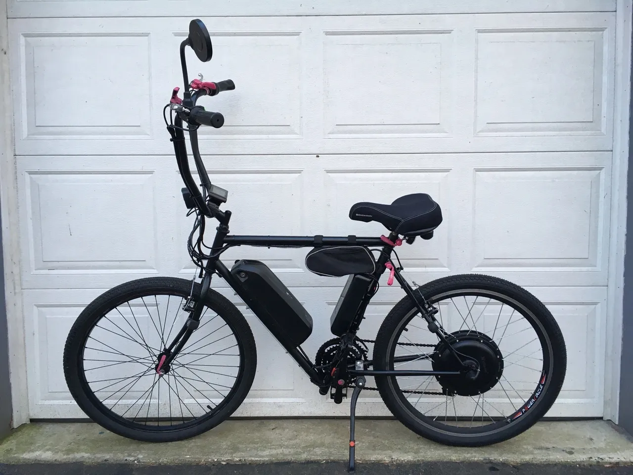 Black electric bicycle with white garage background