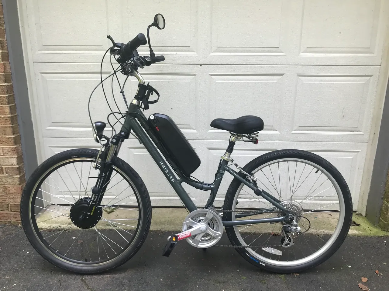 Side view of electric bicycle near garage