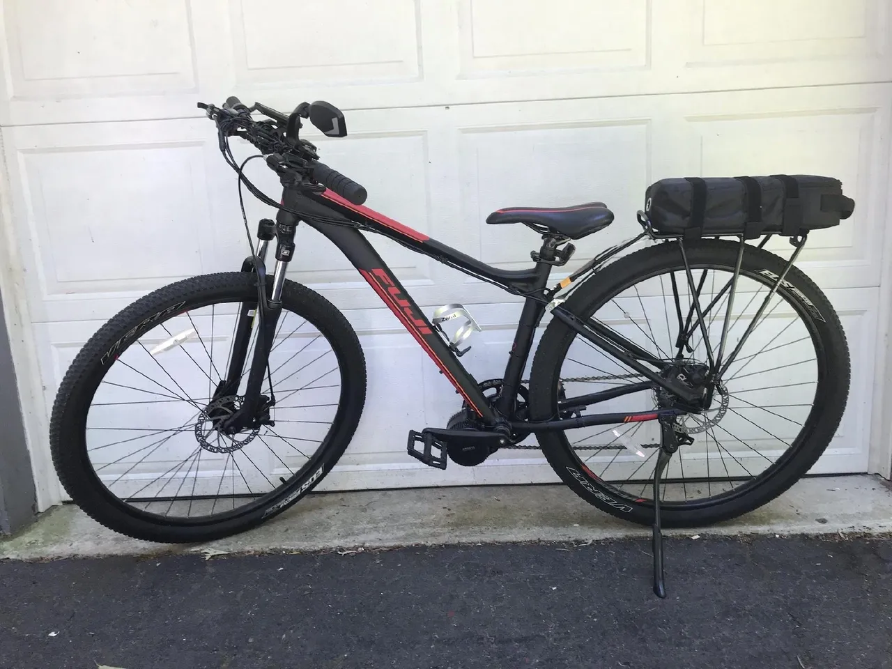 Bicycle parked on driveway by garage.