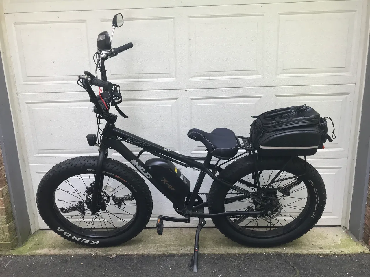Black e-bike with rear storage bag