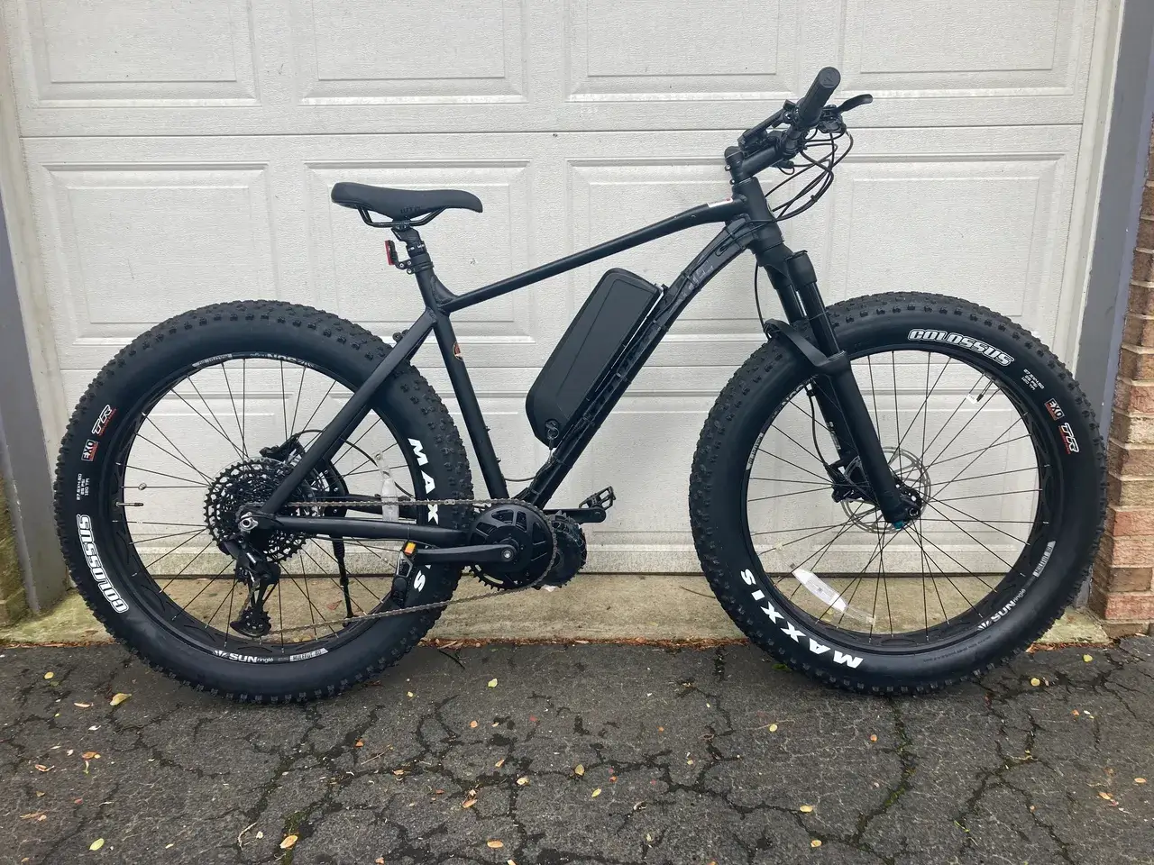 Fat tire e-bike in front of garage