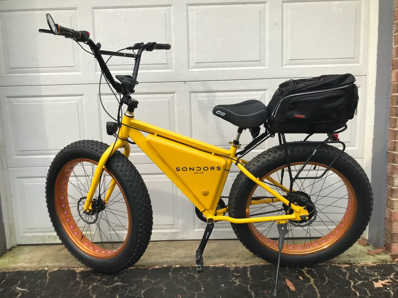 Yellow e-bike with rear storage bag
