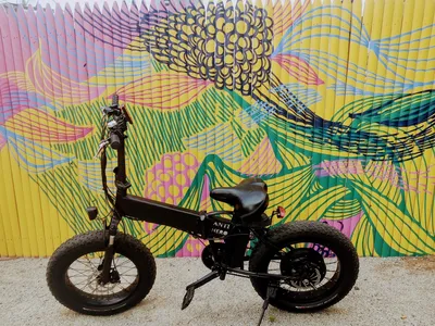 Electric bike against artistic wall