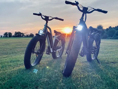 Bicycles with headlights during sunset.